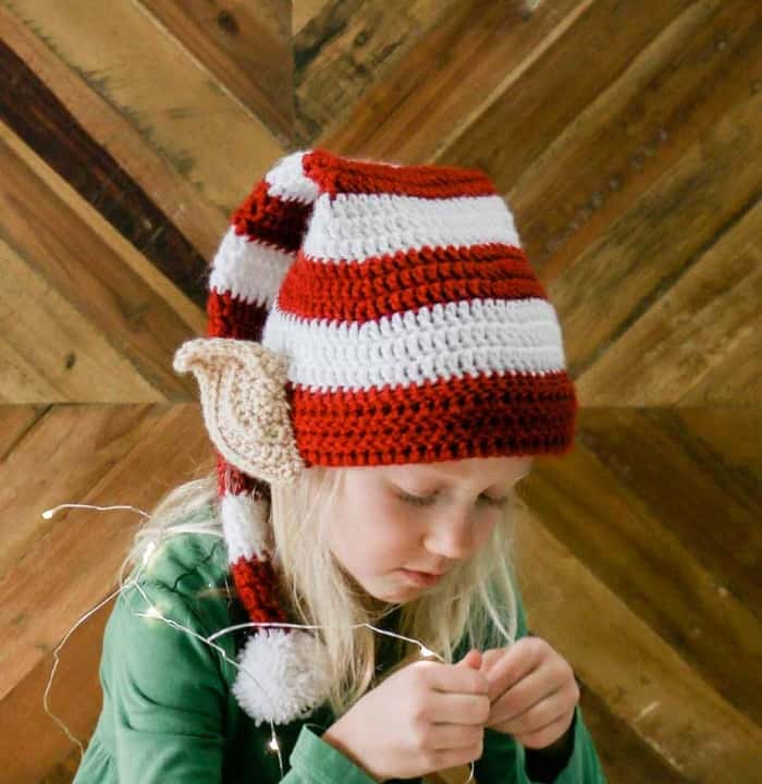 This free Santa's helper crochet elf hat pattern with ears makes a perfect creative family Christmas photo idea! Free pattern and tutorial in sizes newborn, baby, toddler, child, tween and adult. Featuring Lion Brand Vanna's Choice.