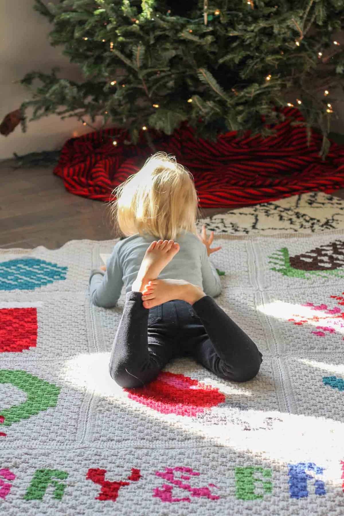 Make an heirloom your family can snuggle up with year after year with this free corner to corner crochet Christmas afghan pattern! These modern c2c Christmas graphs make perfect winter pillows too. Crocheted with Lion Brand Vanna's Choice yarn.