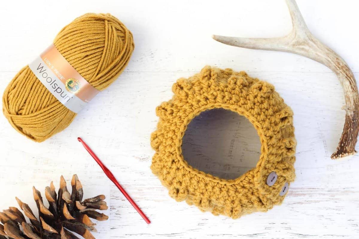 Would you believe this free crochet bun beanie pattern (AKA ponytail hat) is worked in only single crochet and chain stitches? Despite it's simple construction, the "cabled" look of this beanie is sure to dress up even the messiest of messy buns. Made with Lion Brand Lion's Pride Woolspun in "Honey."