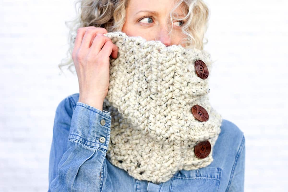 This free crochet cowl pattern uses the herringbone double crochet stitch to create a deliciously chunky scarf with a modern look! The oversized buttons add another element that is endlessly customizable. Pictured in Lion Brand Wool-Ease Thick & Quick in "Oatmeal."