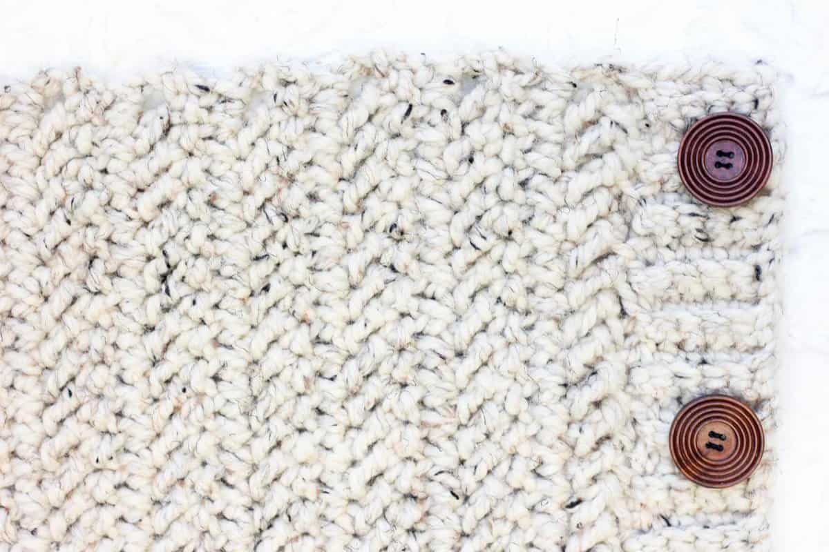 A crochet pattern with herringbone double crochet stitches and two buttons.
