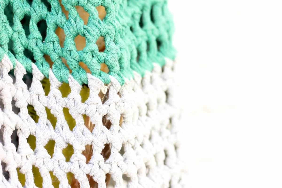 This free market tote pattern and video tutorial is the perfect introduction on how to finger crochet! A speedy, satisfying project for adults and kids alike. Made using Lion Brand's Fast-Track yarn in "Chopper Grey" and "Go Kart Green." | MakeAndDoCrew.com