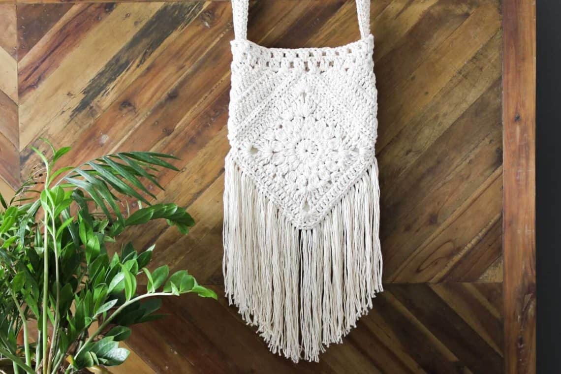 Boho love! This free boho crochet purse pattern is fun to put together and loaded with bohemian charm. Made with Lion Brand Kitchen Cotton in "Vanilla."