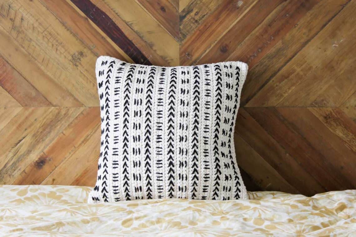 This free crochet pillow pattern uses a mud cloth inspired design to make a modern piece of couch flair! Excellent pattern for beginners! Made with Lion Brand Kitchen Cotton.