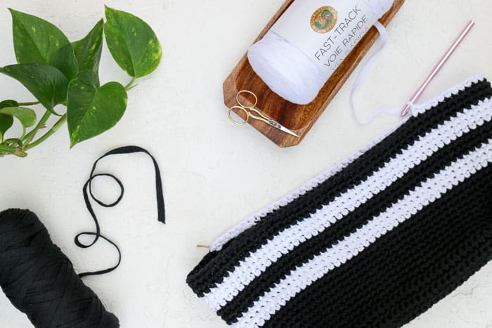 Lion Brand Fast-Track yarn with an in-progress crochet tote bag.