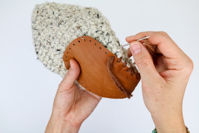 How to add leather soles to crochet or knit slippers. Free slipper soles template from MakeAndDoCrew.com. 