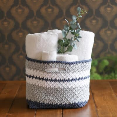 This easy crochet basket pattern is quick to work up and perfect for holding toys, towels, toilet paper, or best of all, yarn! Free crochet pattern using Lion Brand Fast-Track yarn in Chopper Grey, Airstream White, Dune Buggy Denim.