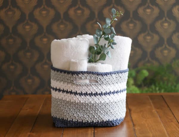 This easy crochet basket pattern is quick to work up and perfect for holding toys, towels, toilet paper, or best of all, yarn! Free crochet pattern using Lion Brand Fast-Track yarn in Chopper Grey, Airstream White, Dune Buggy Denim.