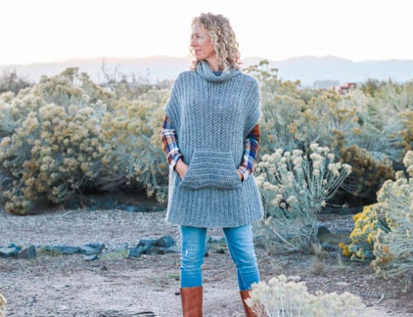 This simple free crochet poncho pattern is a little more fitted than most, offering a versatile wardrobe staple that's perfect for layering. The pocket and cowl turtleneck crank up the cozy factor! Made with Lion Brand Touch of Alpaca yarn in "Grey Oxford."