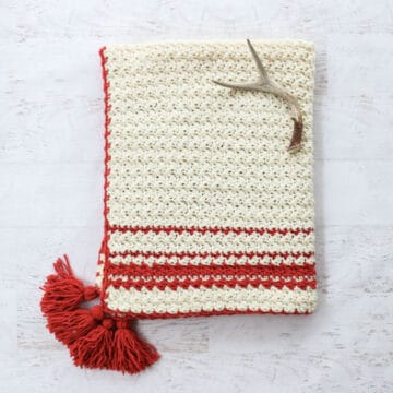 Inspired by classic woven blankets, the Hygge Holiday Throw turns any chair or couch into an inviting spot to curl up. Despite being full texture, this beginner crochet blanket pattern uses very simple crochet stitches (and there's a video tutorial!)