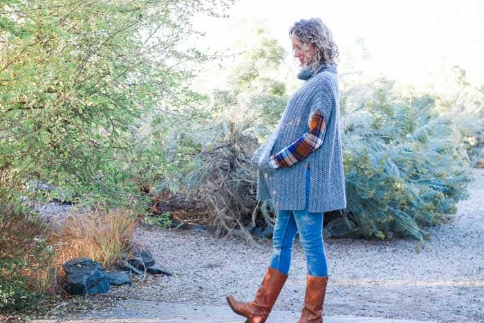 Casual crochet poncho pattern that is perfect to pair with leather boots and jeans for a DIY fall outfit idea. The turtleneck cowl and pocket add an extra dose of cozy!