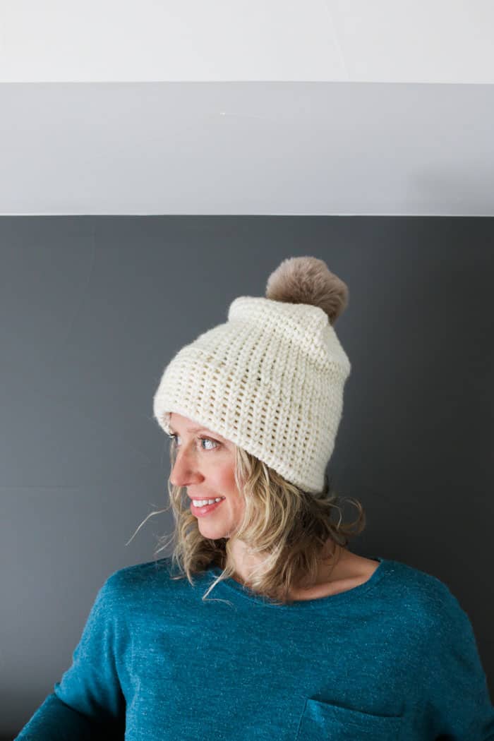 Woman wearing a chunky crochet beanie that looks knit. 