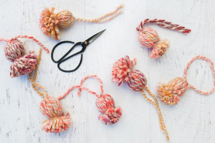 How to make yarn tassels / pom poms using a paper tube or tassel maker featuring Lion Brand Wool-Ease Thick & Quick in the color "Spice Market" (available at Michael's stores.)