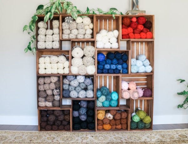 This yarn storage changed my life! Use wooden crates to build an easy shelf to organize your yarn, craft room or books. Perfect for knitters, crocheters and weavers!