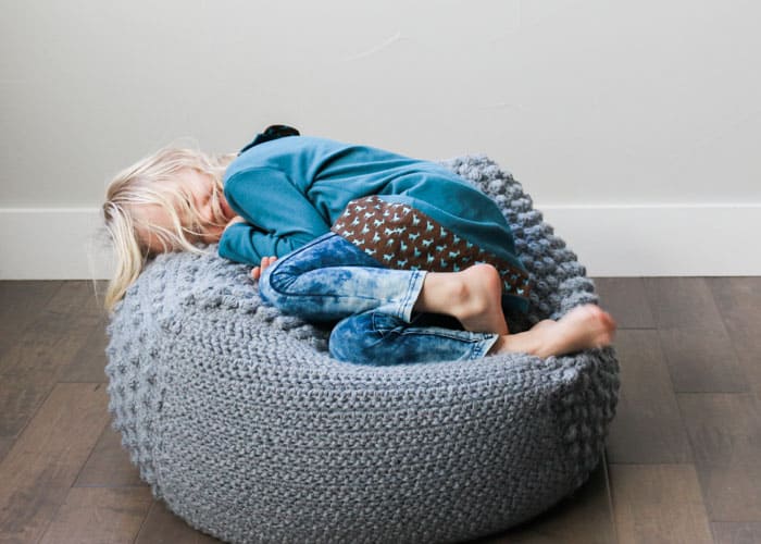 This free crochet bean bag pattern is perfect for a nursery or kids room. Pouf pattern could easily be adapted to knitting too!