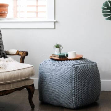 Learn some new stitches while crocheting your own oversized pouf ottoman. This free crochet bean bag pattern is comprised of six simple squares and stuffed with inexpensive household items to create a high-end looking piece of DIY furniture.