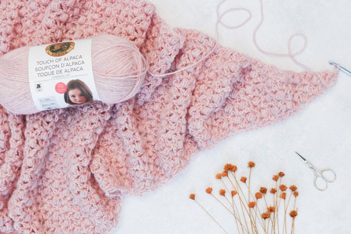 Free puff stitch crochet shawl pattern using Lion Brand Touch of Alpaca yarn in the color "Blush."