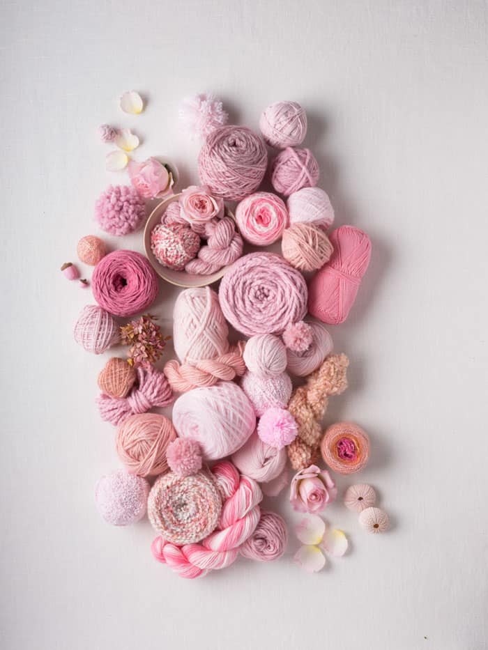 A beautiful collection of Lion Brand yarns in varying shades of pink, mauve, rose and antique.
