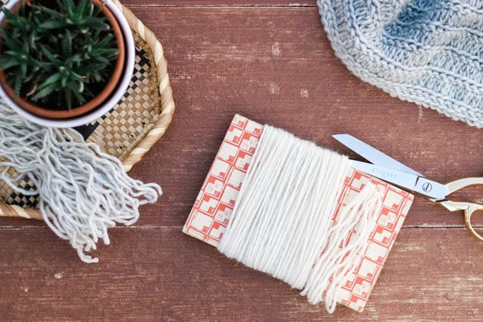 How to cut fringe for a crochet project by wrapping yarn around a book. 
