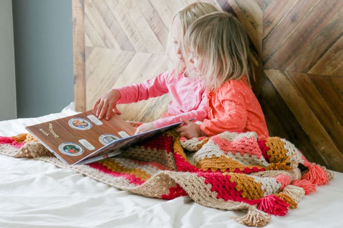 Free pattern for a child's granny stitch crochet afghan pattern featuring Lion Brand Heartland yarn. Love the tassels!