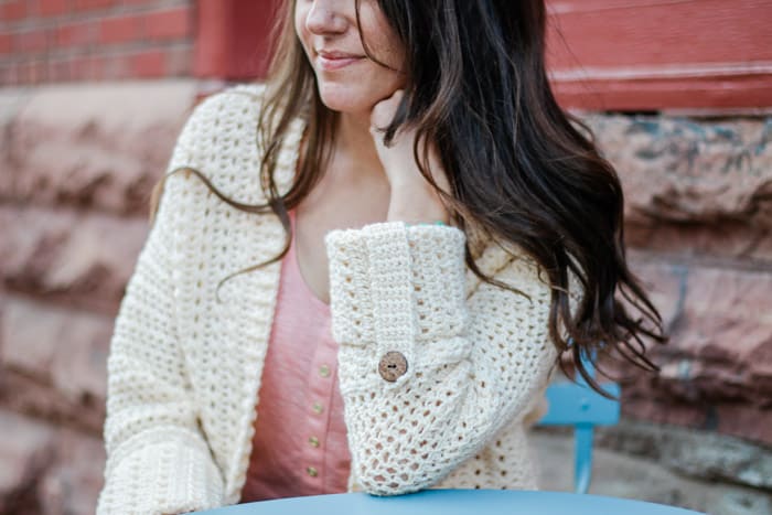 A lightweight summer crochet cardigan with cuffed sleeves and wooden buttons. Free pattern and video tutorial from Make & Do Crew.