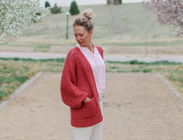 Two simple crochet hexagons transform into a lightweight, on-trend cardigan complete with cozy pockets and roomy bishop sleeves. This easy crochet sweater pattern and tutorial makes a great first garment for beginners and is perfect to wear in the spring or summer.