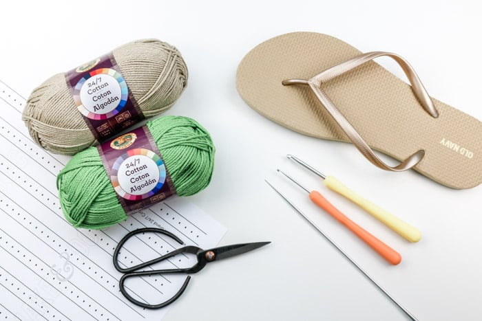 The supplies necessary to learn how to crochet shoes with rubber flip flop soles using Lion Brand 24/7 Cotton.