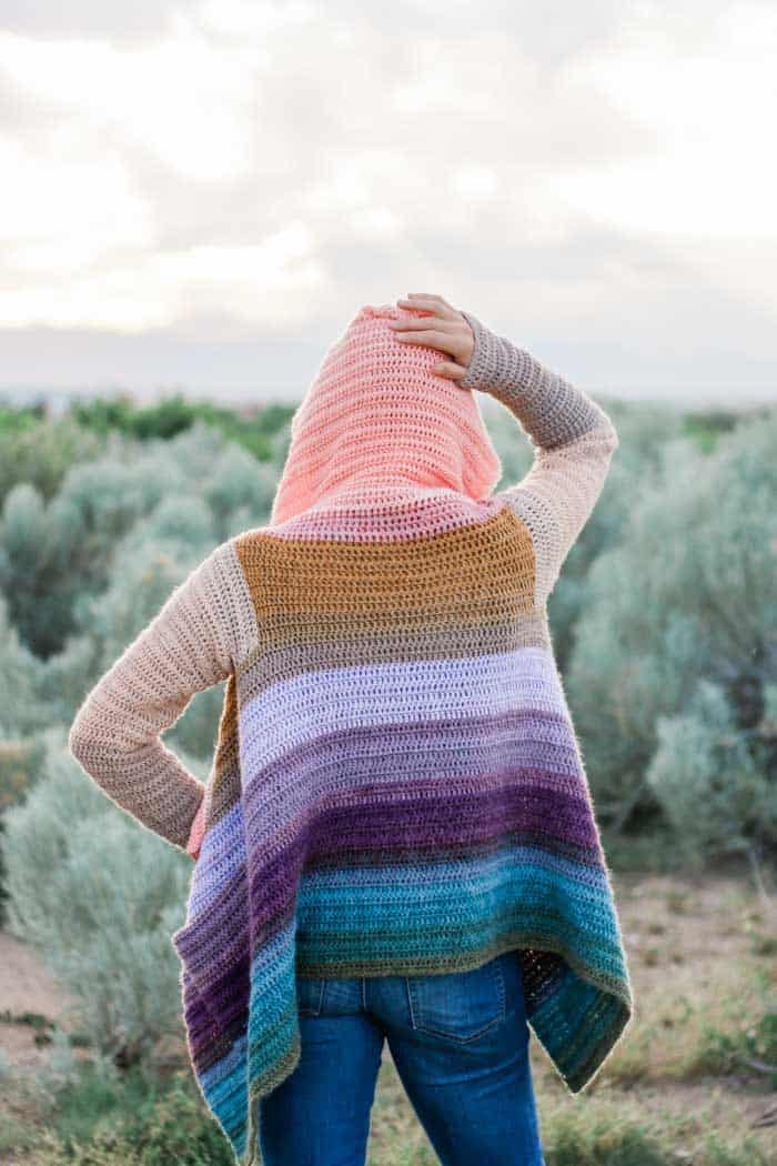 WOW! This beautiful draped cardigan is made by remixing cakes of Lion Brand Mandala yarn to form new gradient stripes. There are very few ends to weave in on this beginner-friendly free pattern and tutorial.