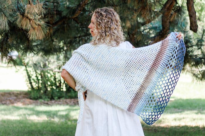 This easy asymmetrical crochet shawl pattern is made from simple puff stitches and lace. Free pattern featuring Lion Brand Ice Cream and Mandala yarn.