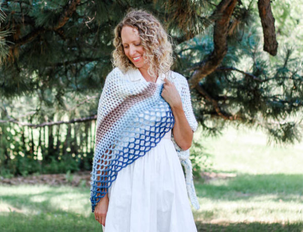 This beautiful crochet shawl pattern is made from an asymmetrical triangle using puff stitches and easy lace. Great crochet scarf pattern to use Lion Brand Mandala, Caron Cakes or Sweet Rolls.