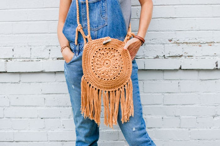 This easy crochet hippie purse pattern is made from Lion Brand 24/7 Cotton yarn and two simple circles. Great bag for adding boho style to your handmade wardrobe.