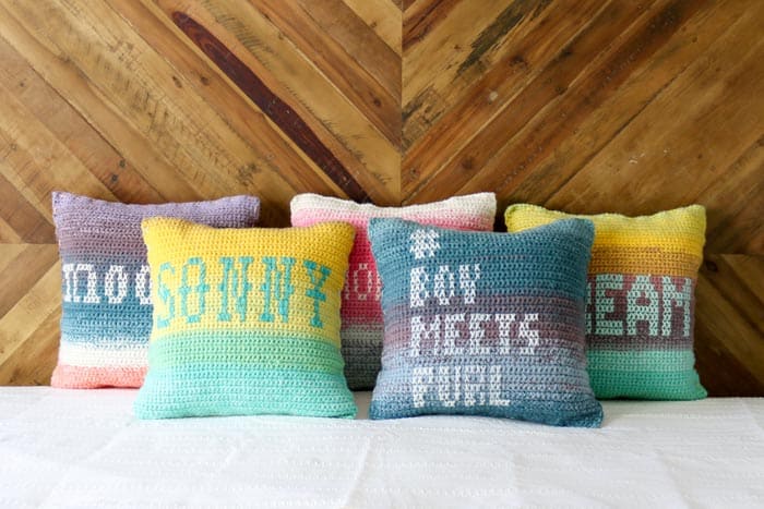 Free crochet pillow pattern made with Lion Brand Mandala Yarn. Personalized cross stitch messages adorn each crochet pillow front.