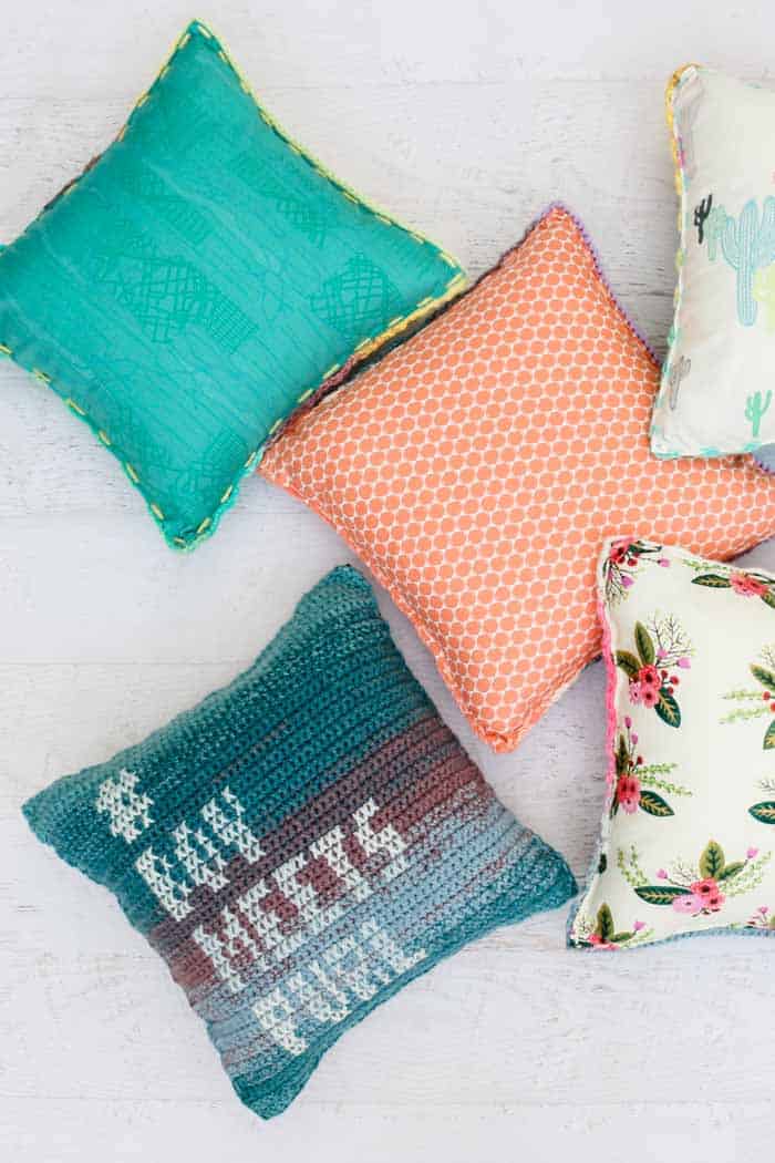 Colorful crochet pillows with personalized cross stitch messages. Adding a fabric backing makes these cushions faster to crochet.