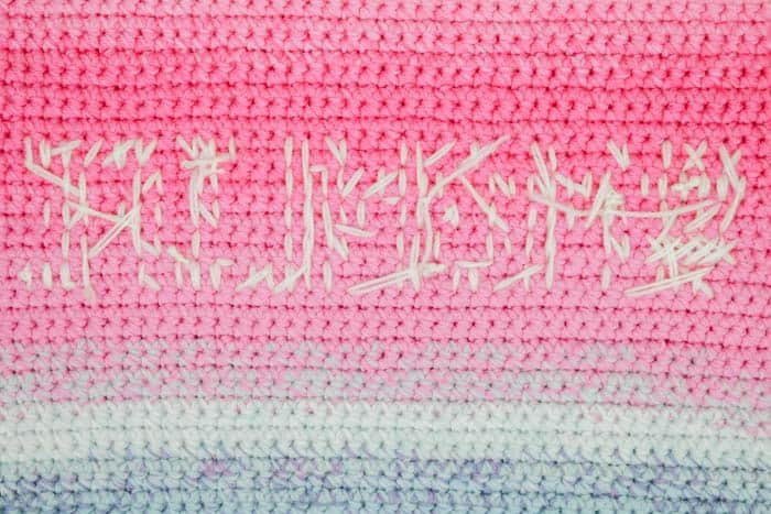 The back side of cross stitch on crochet looks messy, but it's okay because it's hidden inside the pillow.