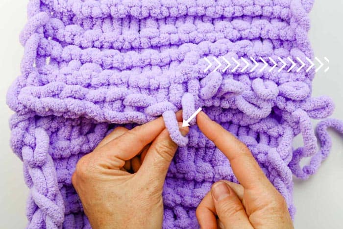 Learn how to bind off in finger knitting with loop yarn in this beginner video tutorial.