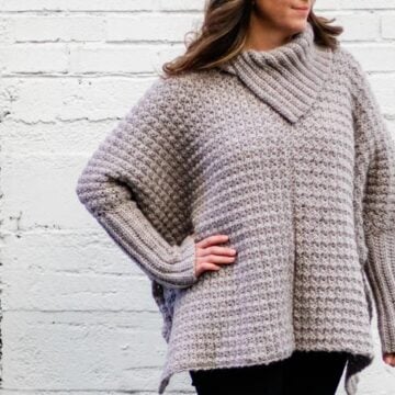 This easy crochet poncho with sleeves looks like a sweater and is made from simple rectangles. Great free pattern for beginners!
