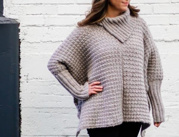 This easy crochet poncho with sleeves looks like a sweater and is made from simple rectangles. Great free pattern for beginners!