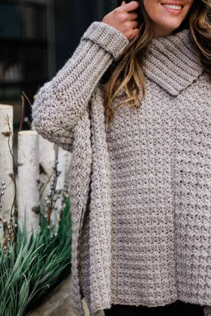 Free crochet poncho pattern with sleeves featuring the sedge crochet stitch. Made using Lion Brand Touch of Alpaca yarn in "Taupe."
