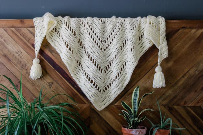 The intriguing repeat of basic stitches in this chunky crochet triangle scarf will hold the interest of beginning and more experienced crocheters alike. Perfect boho crochet scarf pattern for winter!