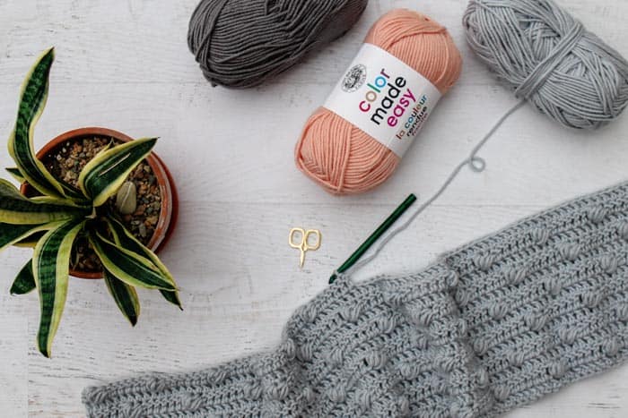 An in progress crochet bobble cardigan using Lion Brand Color Made Easy yarn in Slate. (Millennial and Basalt also pictured.) 