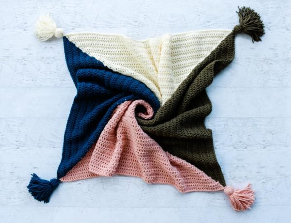 Easy and free four color crochet square blanket pattern with baby and throw sizes included. Perfect tasseled blanket for modern nurseries or decor.