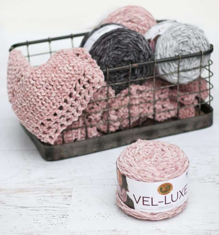 Free crochet cardigan pattern using Lion Brand Vel-Lux velour yarn in the color "dusty pink."