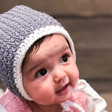 Modern easy crochet baby bonnet pattern that makes a perfect baby shower gift or family heirloom. Free pattern + tutorial.