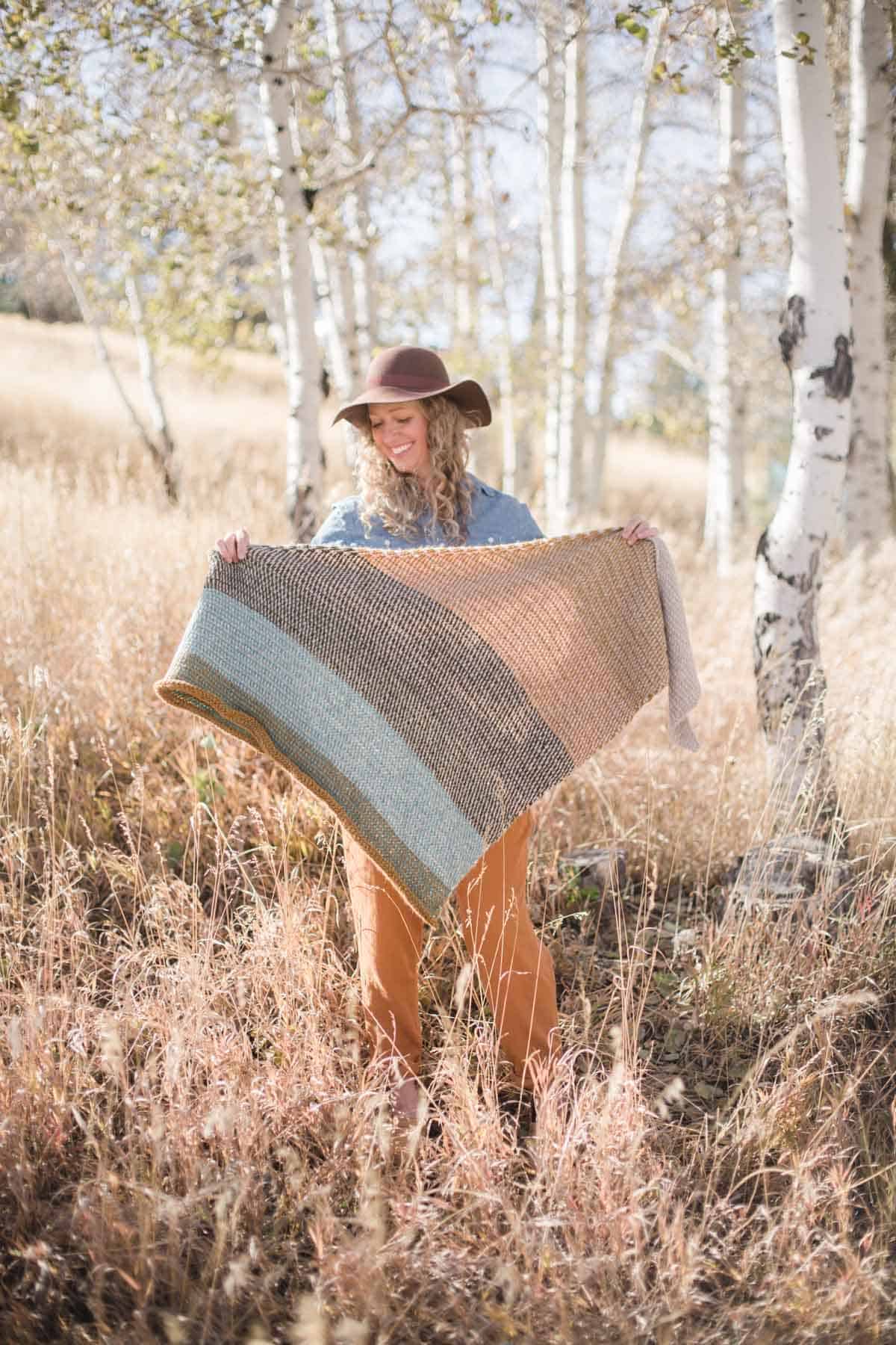 Woman holding modern Tunisian crochet shawl