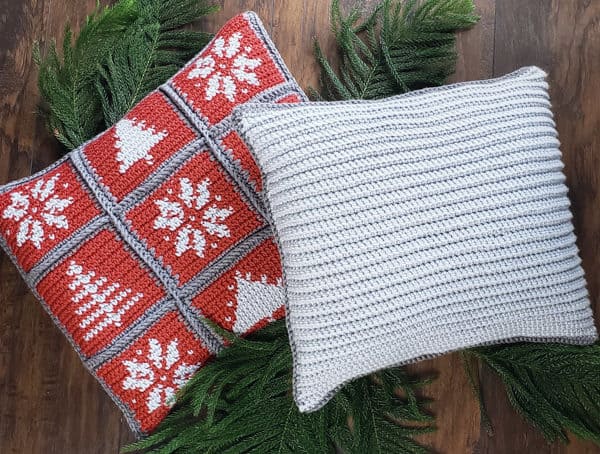 Christmas pillows made of individual crochet squares. Each square has a winter image. These holiday pillows are made by tapestry crochet with Lion Brand Yarn. Free pattern + tutorial.