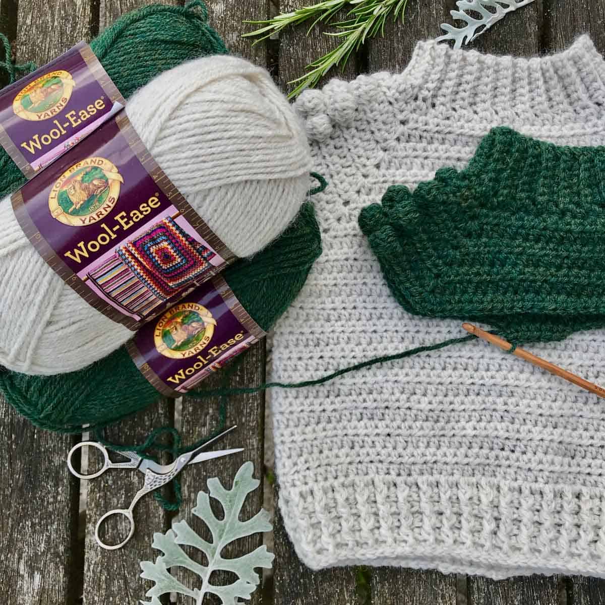 Free crochet pattern for a children's pullover sweater made with Lion Brand Wool-Ease yarn in colors Natural Heather and Forest Green Heather.