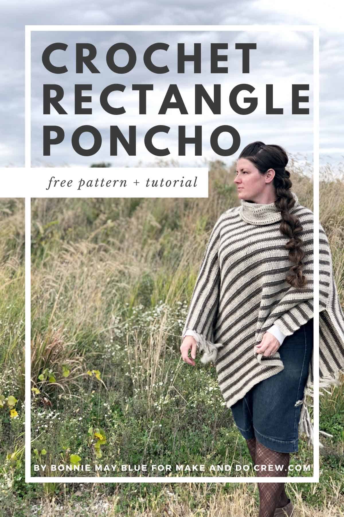 Woman wearing a crochet poncho with fringe standing in an open field.