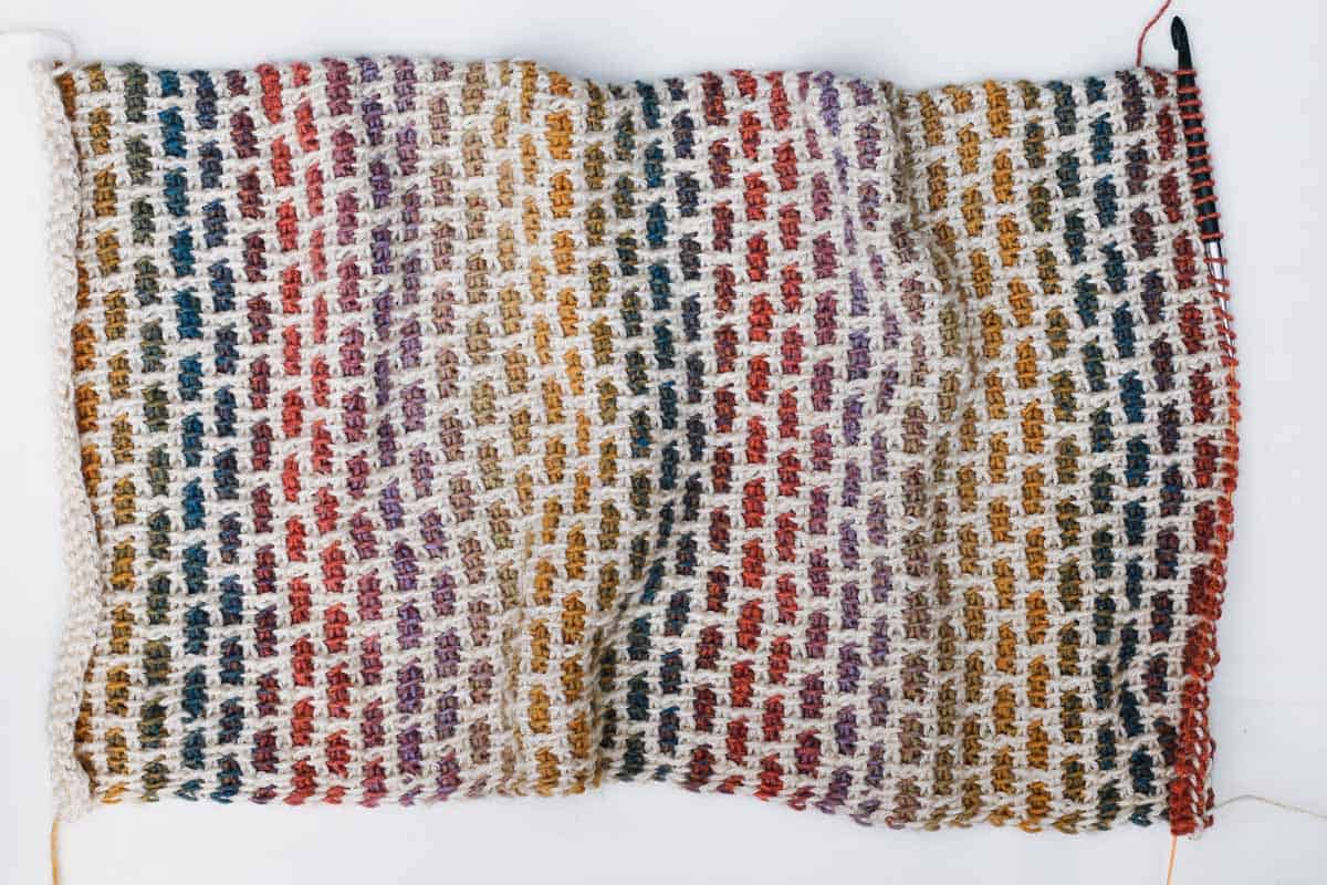 The Tunisian crochet brick stitch using Lion Brand Ferris Wheel yarn in the color Buttercup and Heartland yarn in the color Acadia. Really interesting Tunisian crochet stitch to make beautiful, muted rainbow hues.