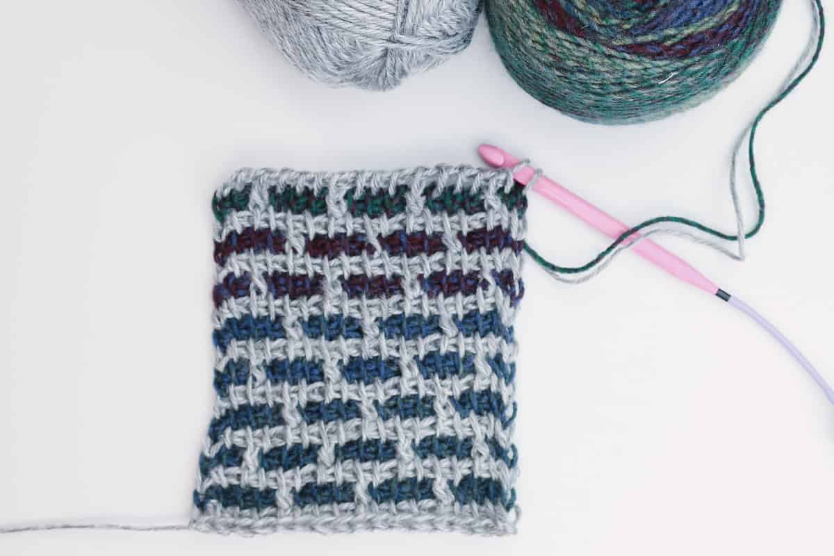 Swatch of a beautifully modern Tunisian crochet stitch called the grid stitch (brick stitch) made with Lion Brand Ferris Wheel Yarn in the color Imaginary Garden.