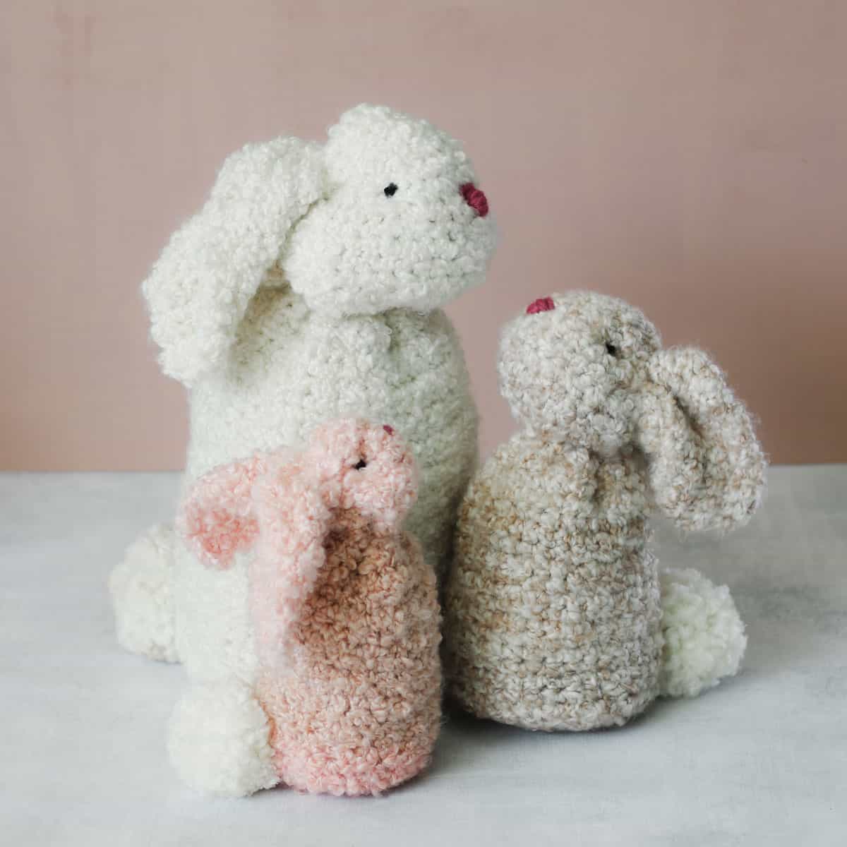 Three crochet bunnies made from rectangles and Lion Brand Homespun Thick & Quick yarn.